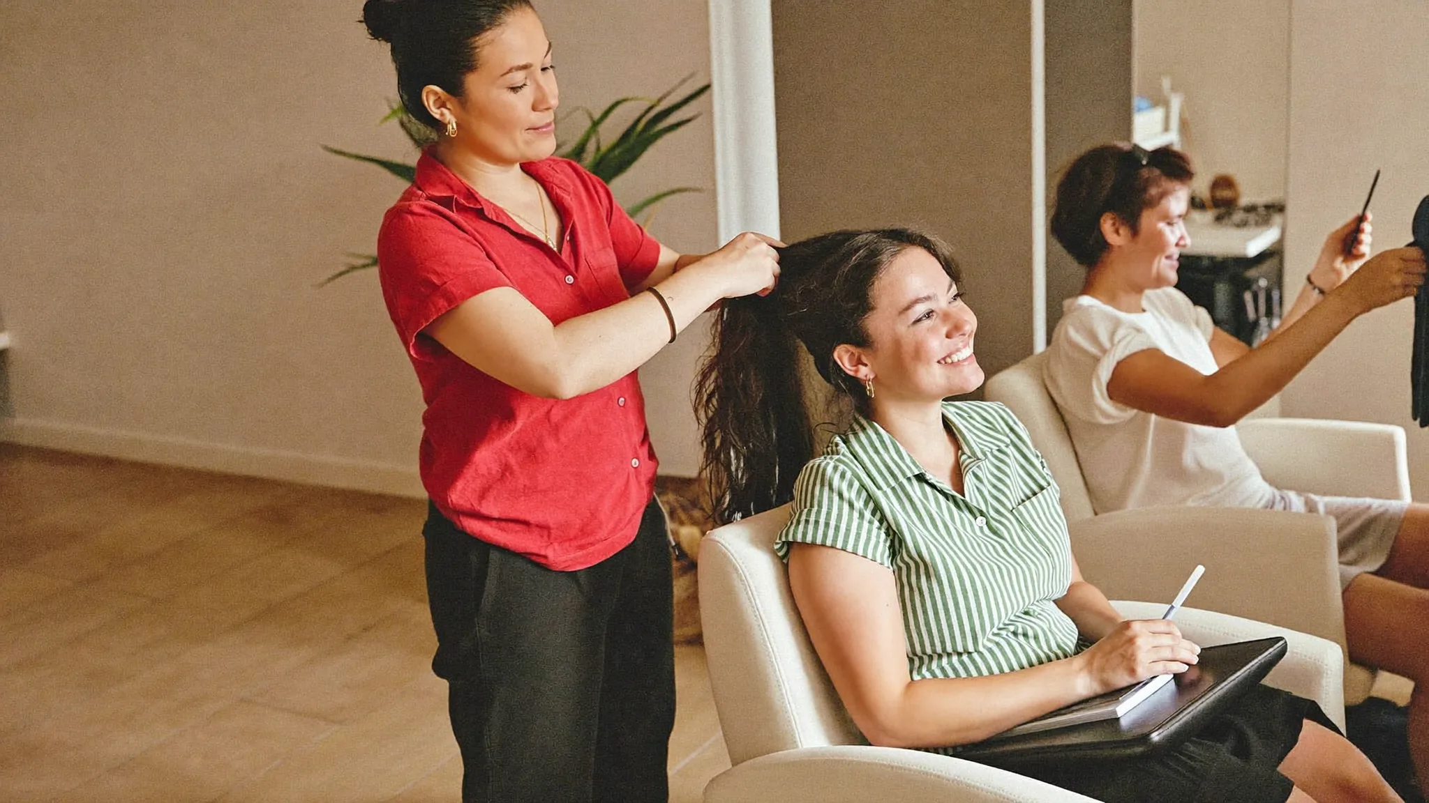 Hair stylist working with a client at a salon chair