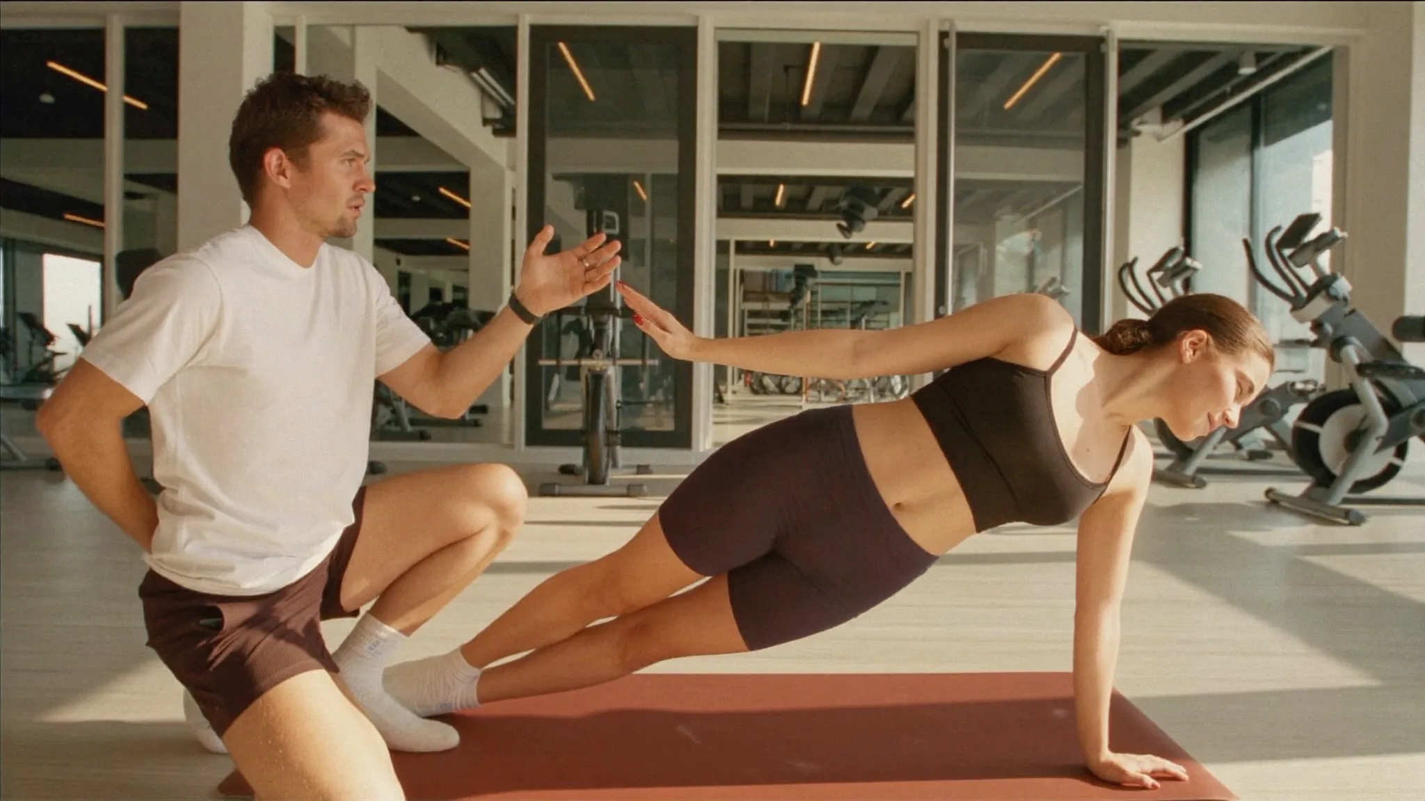 Personal trainer coaching a client through a workout session
